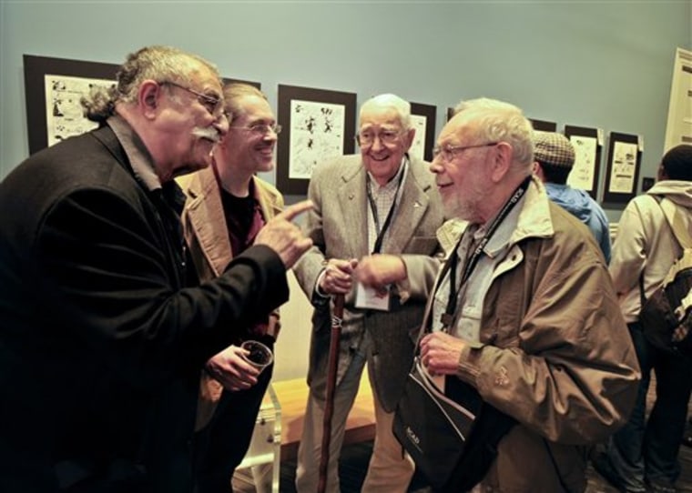 Mad Magazine cartoonists Sergio Aragones, left, Jack Davis and Al Jaffee, right, speak with Savannah College of Art and Design professor John Larison, second from the left, during an event hosted by SCAD and the National Cartoonists Society, Friday, in Savannah, Ga. Aragones, Jaffee and Davis are among eight veteran MAD contributors gathering Saturday for a rare reunion. 
